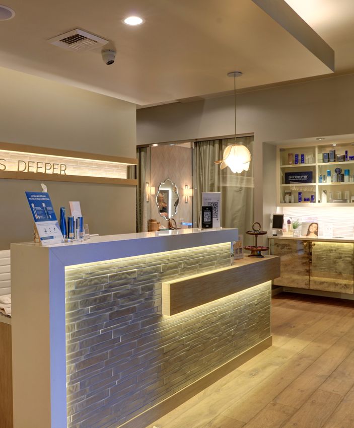 Modern spa reception area with illuminated decor.